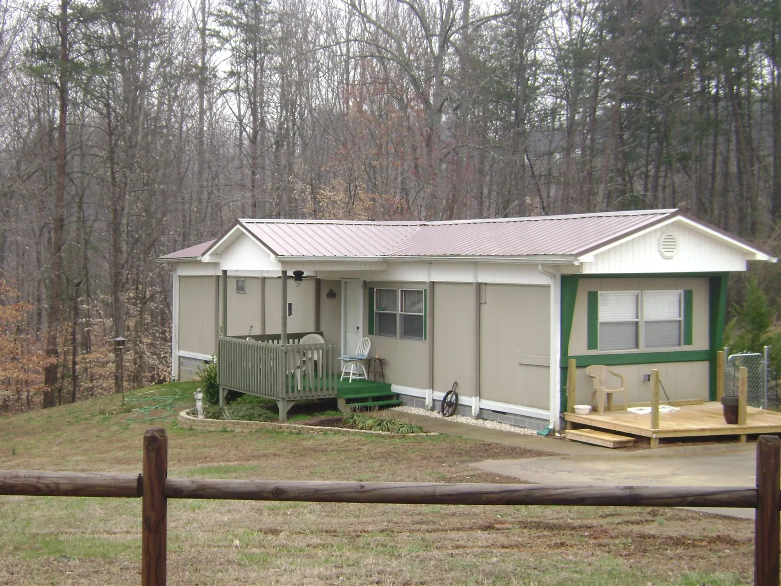 Mauve metal roof on a manufactured home with a new front deck in Aledo